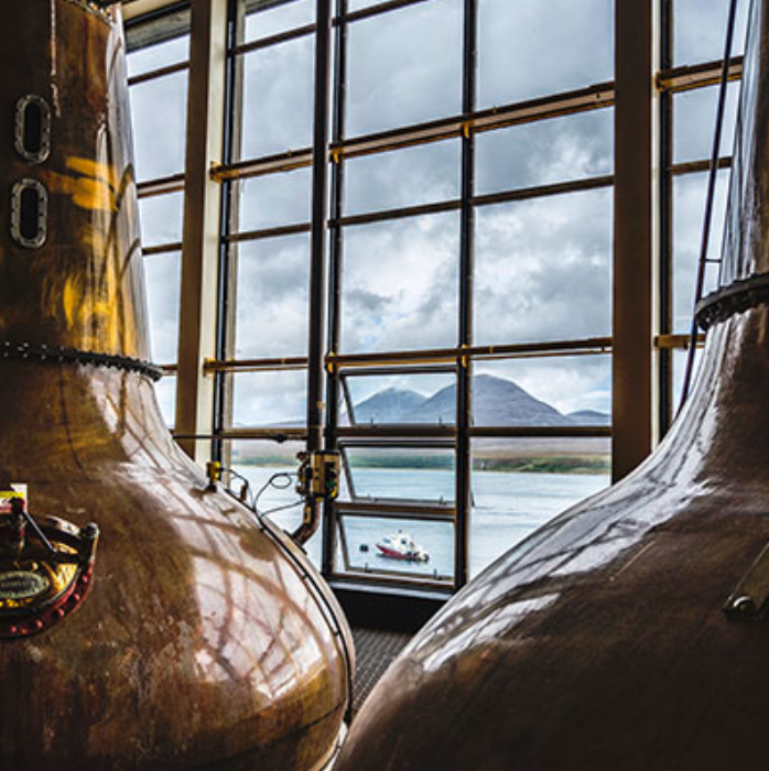 Caol Ila stills with a view of the Isle of Jura. Picture from: https://www.malts.com/en-row/distilleries/caol-ila/